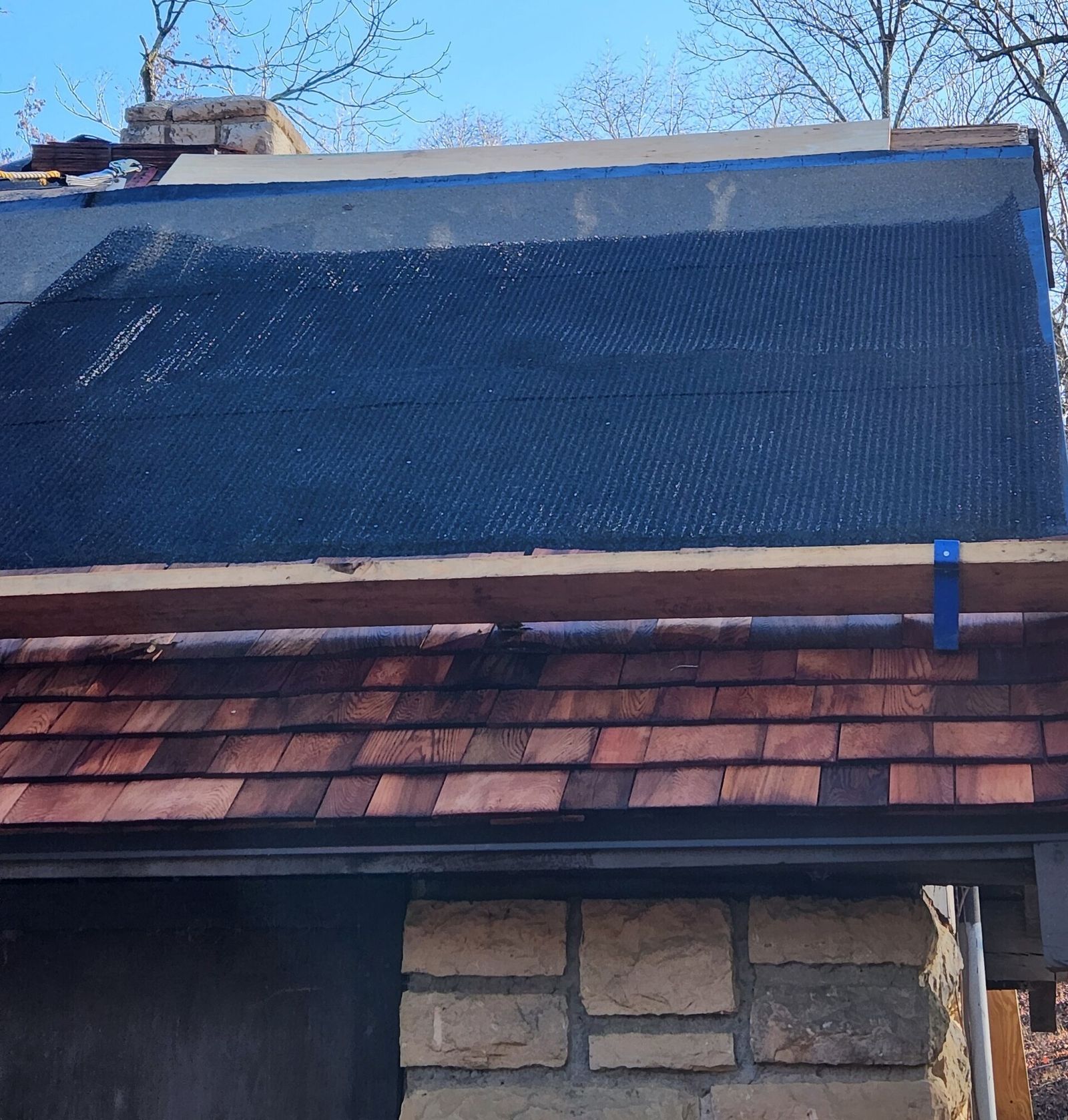Mike marking a repair area on a Palatine roof during an inspection